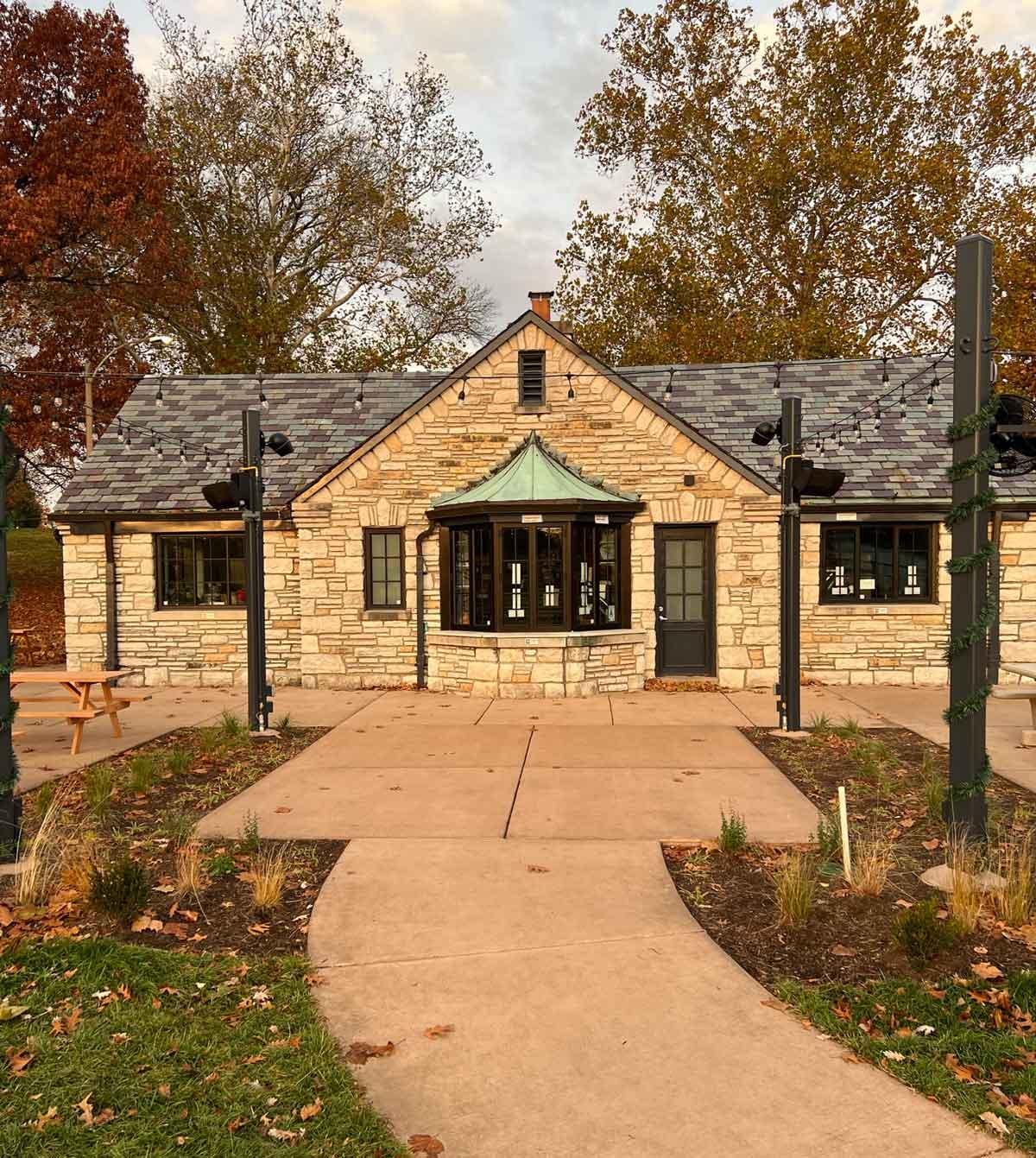 Front view of Rockwell Beer Garden, which features a stone exterior and several 1150S Winco Windows with black trim and a black front door.