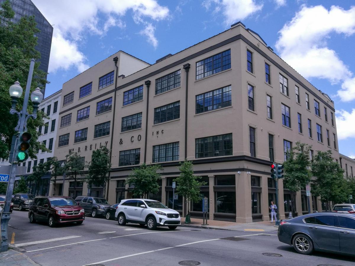 A corner shot of 640 & 618 Magazine Street in New Orleans, a three to four-story building with multiple windows on every side.