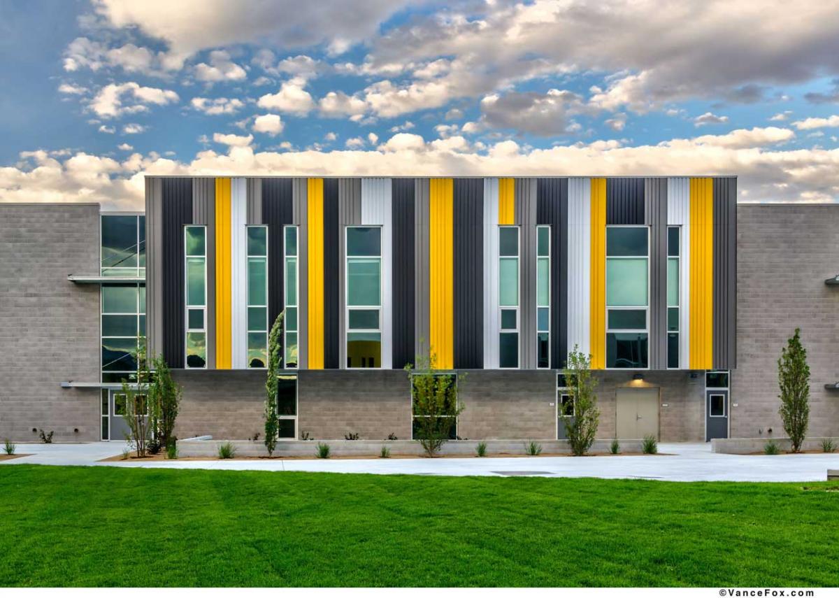 Yellow building with shades between windows.