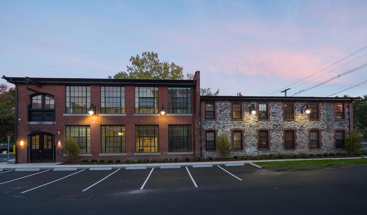 Winco Series 3250 Historic Steel Replica window system with a black anodized finish and exterior grid replicate the look of the original windows.