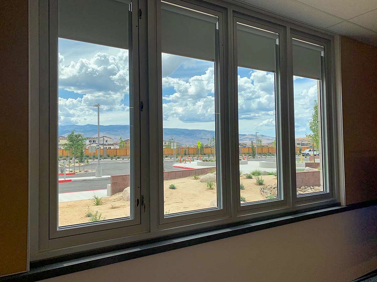 Students in the Washoe County School district in Reno, Nevada benefit from the abundant natural light conditions in multiple ways These four windows all have shades. These windows overlook a parking lot.