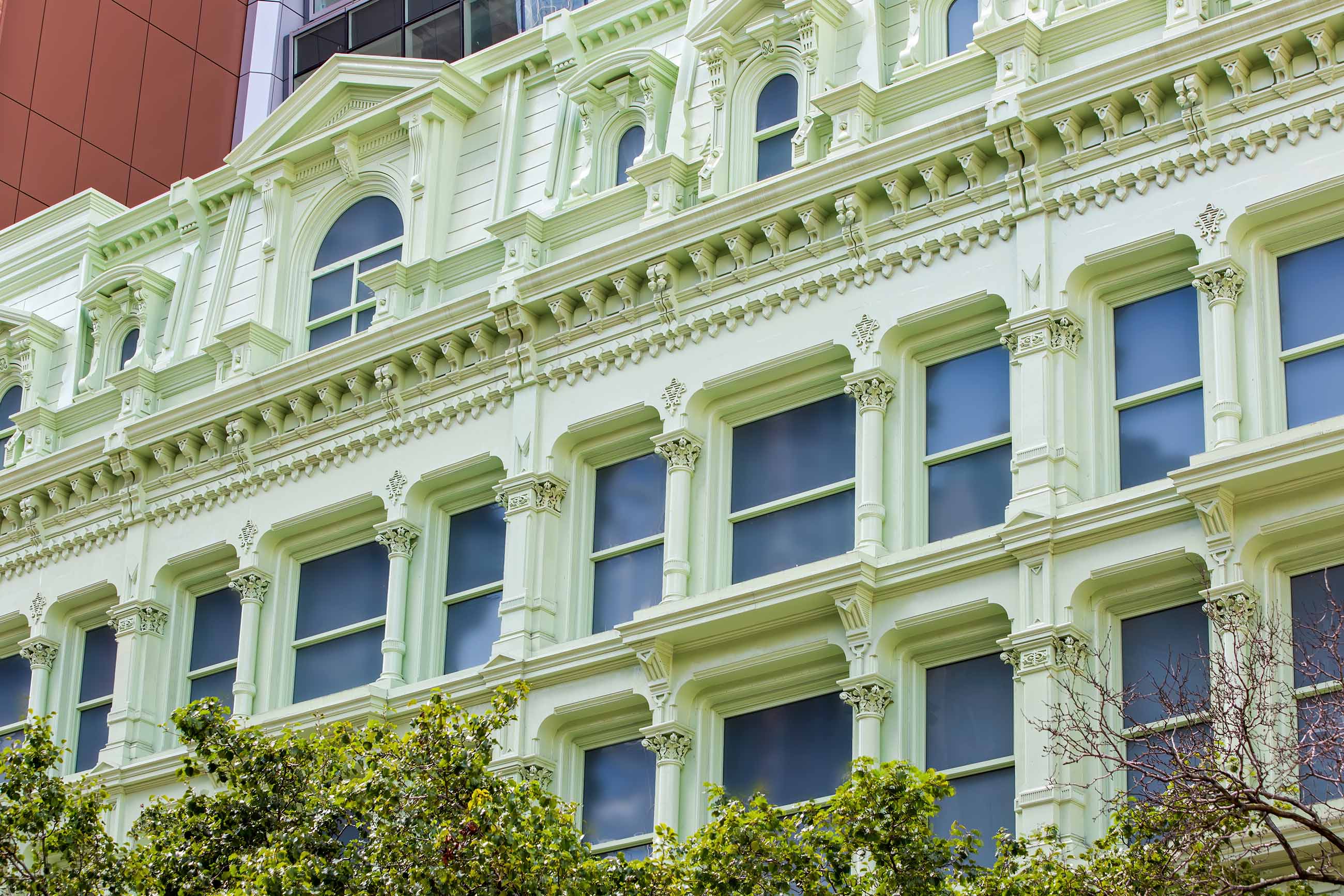 Macy's original windows were replicated using WINCO’s 1450 Hung Replica Window Series set in metal frames, finished with a Kynar paint that matches the lily pad green of the surrounding framework.