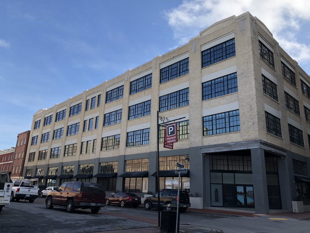 large brick building with large windows with black grids