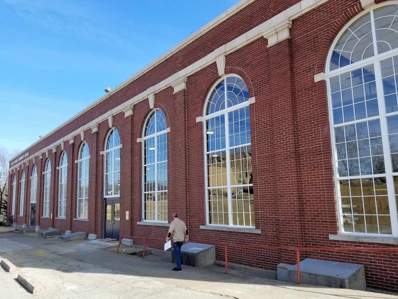 Side of brick building with large steel replica windows