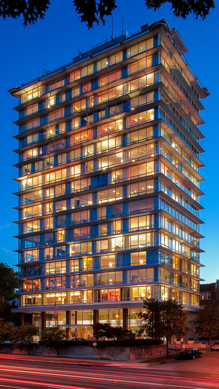 Night view of a tall building with illuminated window wall, featuring Winco’s custom 1450 Window Series for historic compliance.