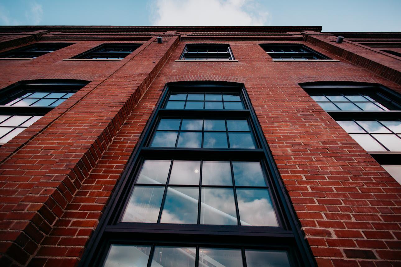 Close up of brick building with large historic replica window