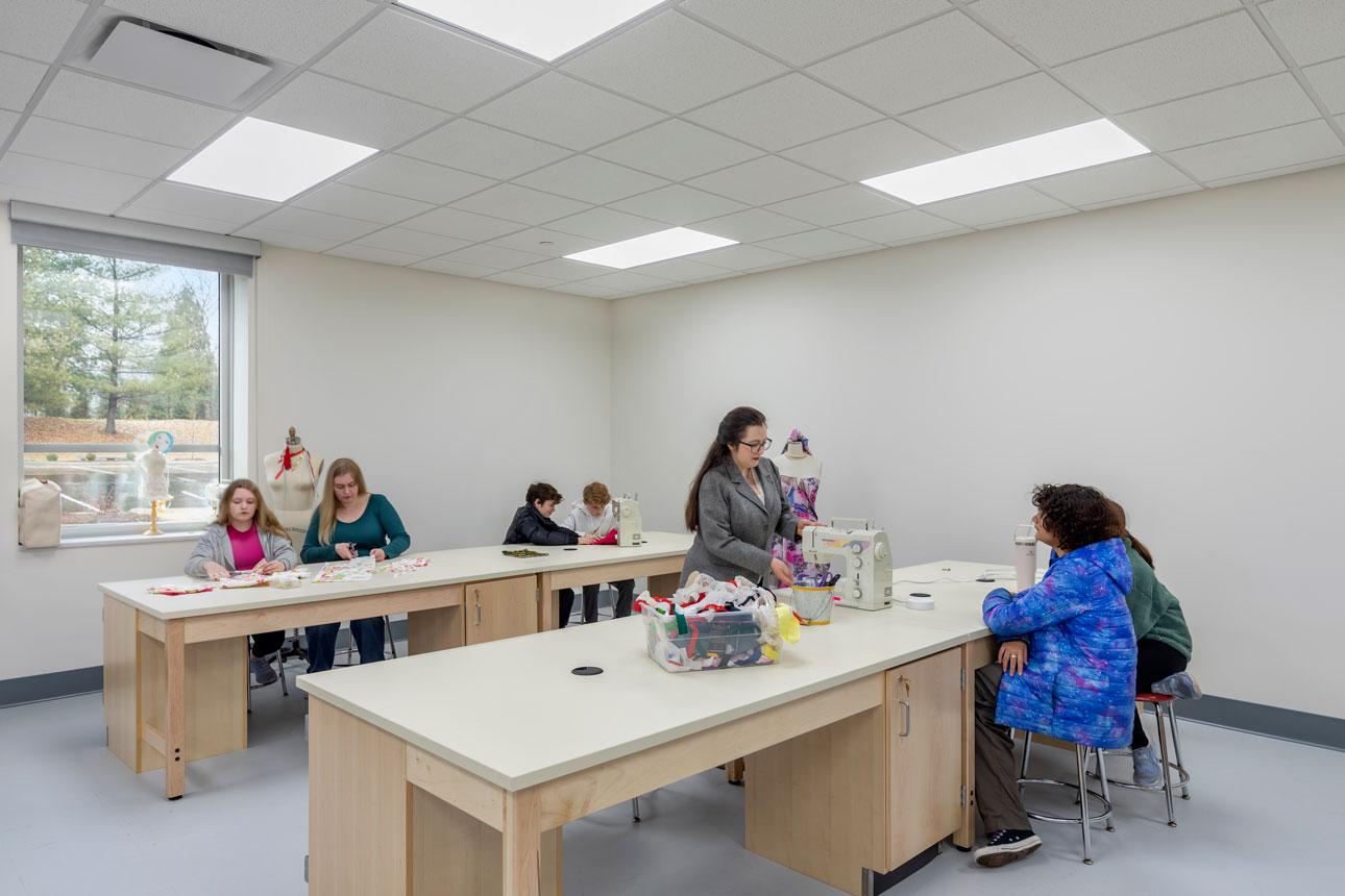 Interior classroom with desks and students with a FEMA window in the background.