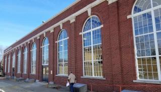 Historic brick building with large steel replica windows